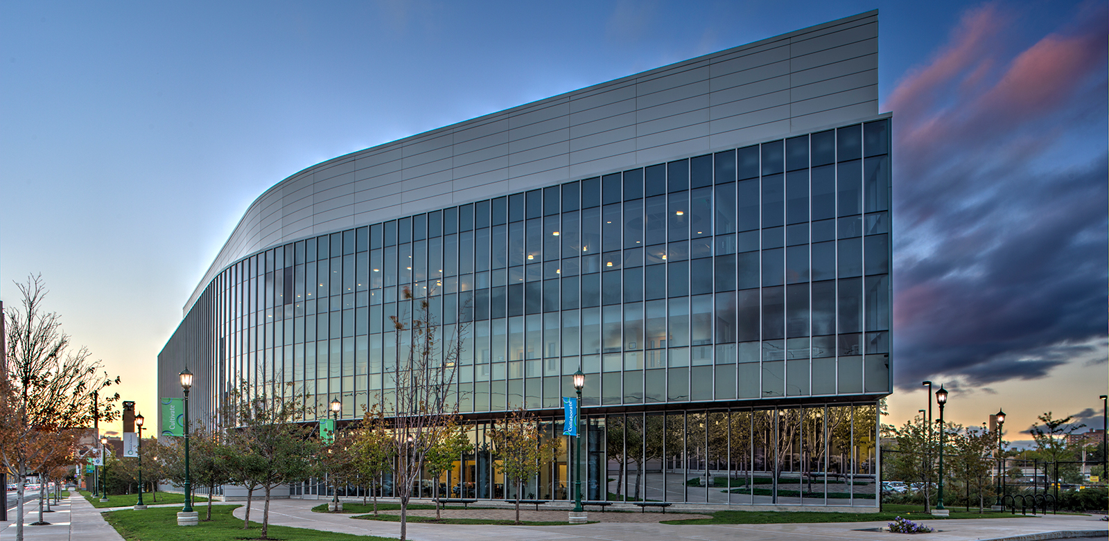 Glass innovation center at dusk in downtown Syracuse