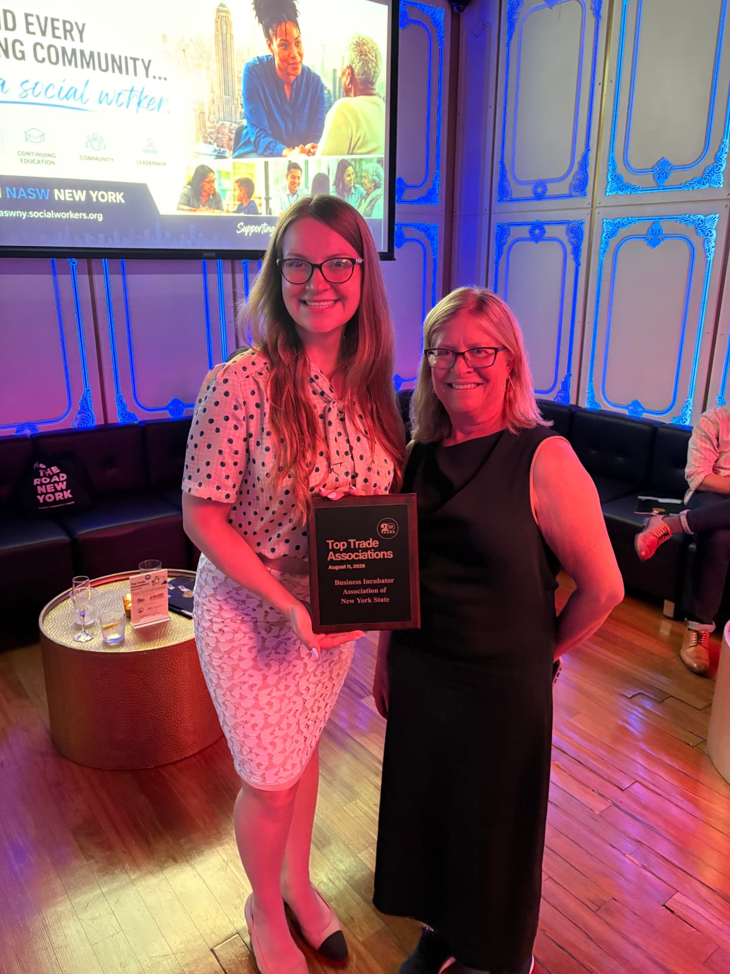 Ariella Trotsenko and Deborah Novick holding the Top Trade Associations award plaque